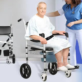 Man in a wheelchair with a nurse assisting him, on a plain background